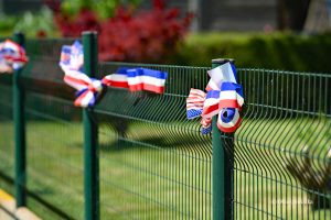 Francuskie i amerykańskie kokardy na ogrodzeniu, 80. rocznica lądowania aliantów w Normandii
